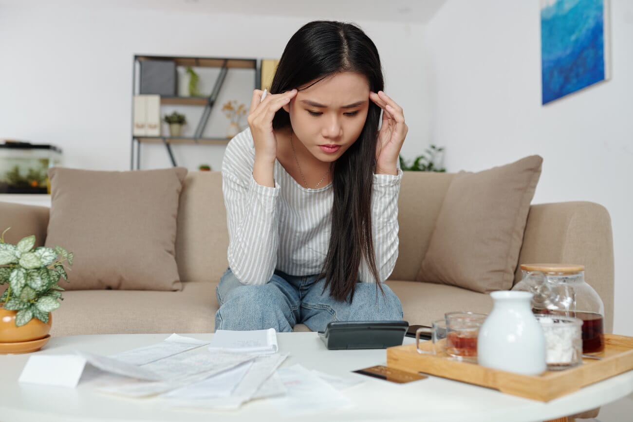 Stressed woman calculating expenses