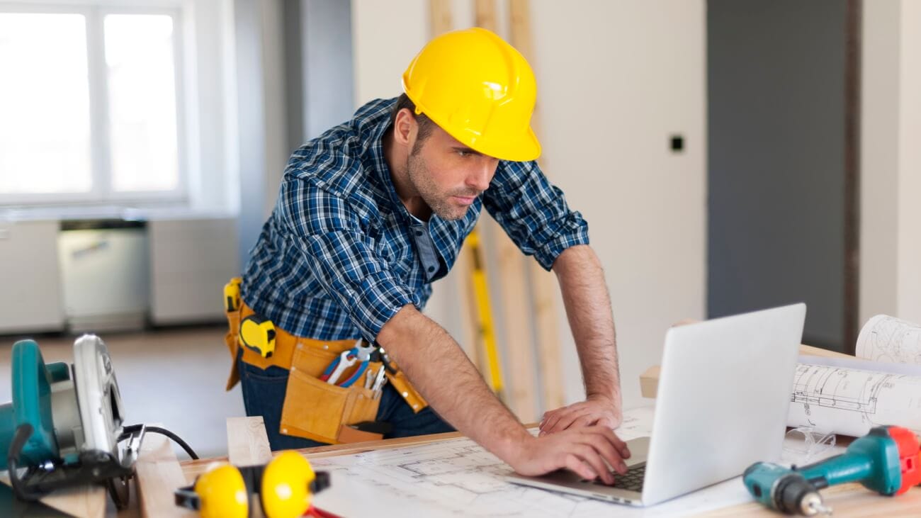 Insurance claim contractor looking at laptop